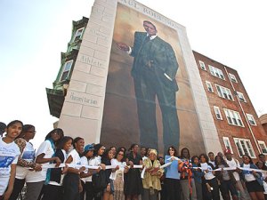 (Students from Paul Robeson High School help to rededicate the Paul Robeson mural. Photo by Steve Weinik, provided.)